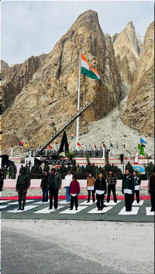 The Indian flag flying against a rock face, mats laid out below