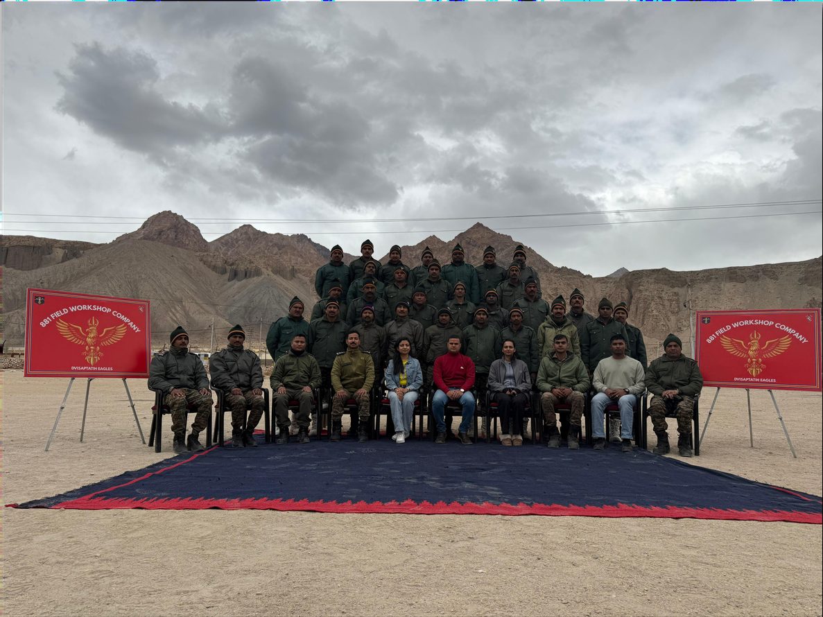 Maj Smita Verma seated with Army, ITBP and Ladakhi personnel after a session, mountains behind